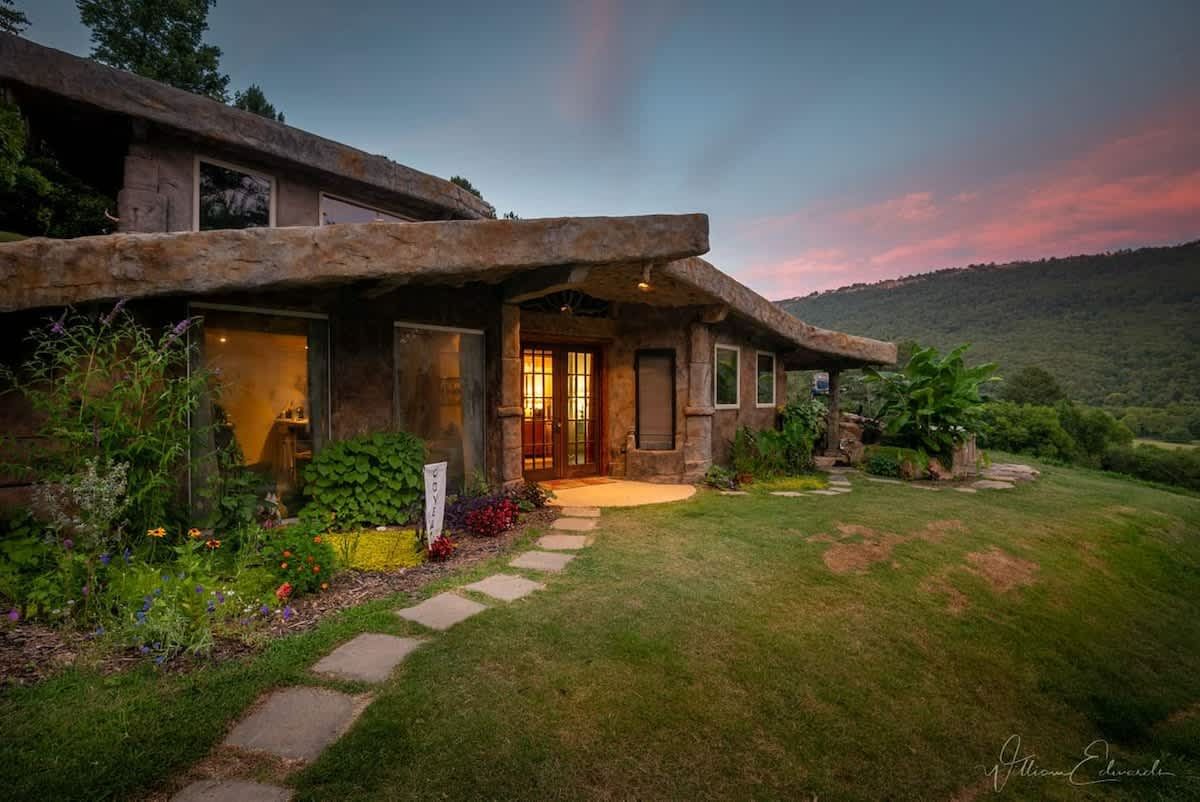 The carved stone cottage at sunset, a stone path leading to the door
