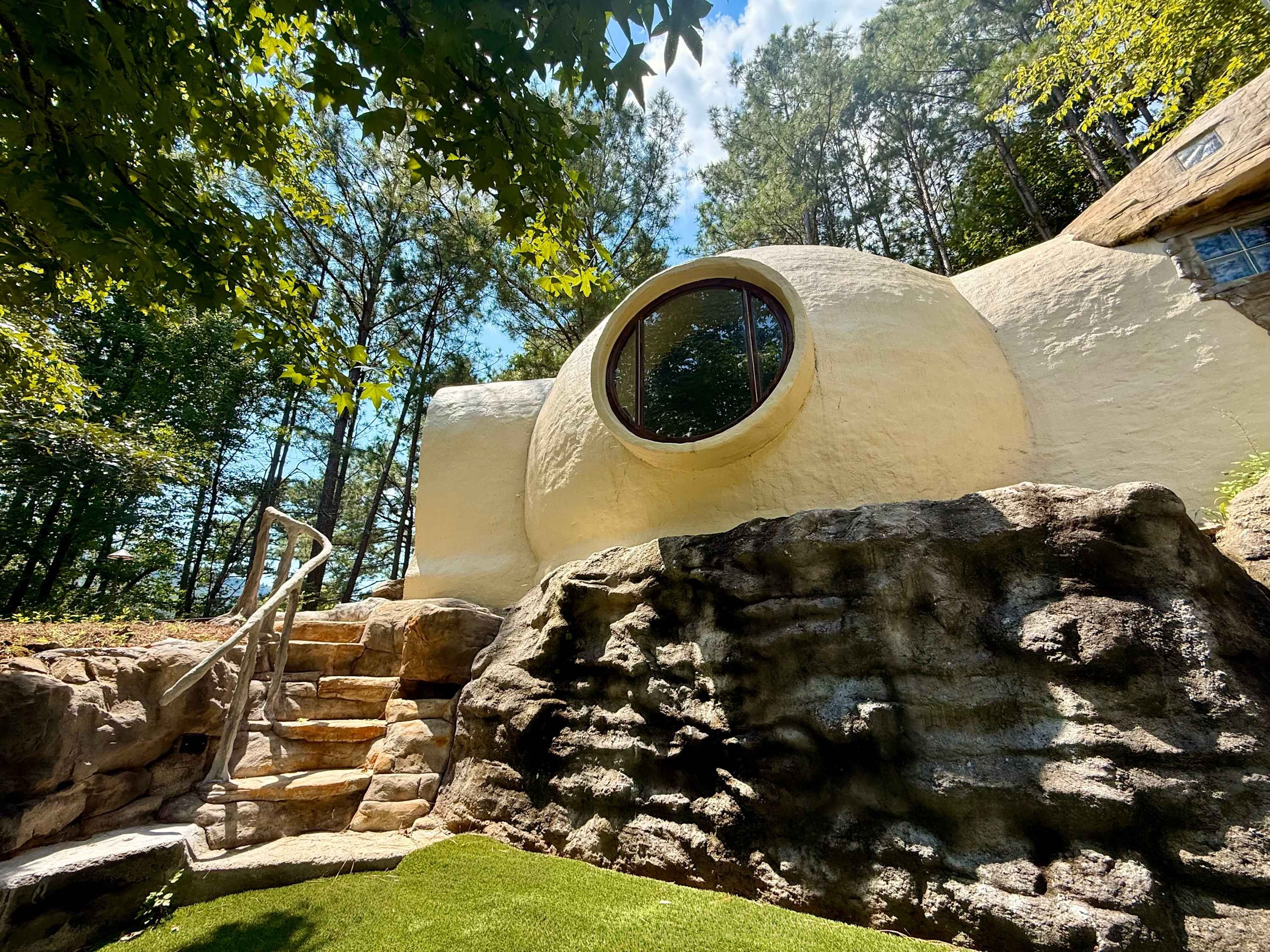 The white dome and its round window above a rock garden