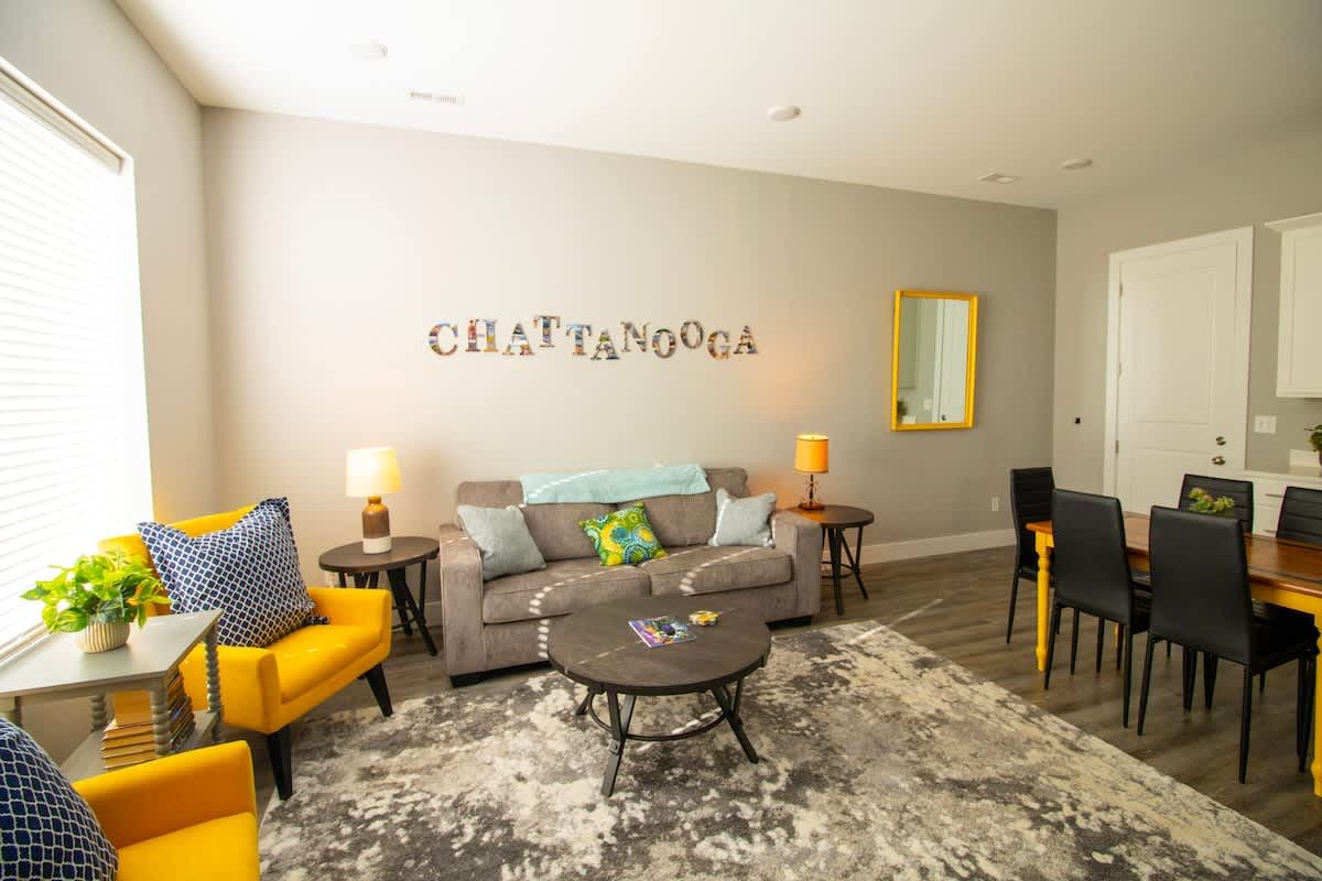 Living room with yellow armchairs and a Chattanooga sign