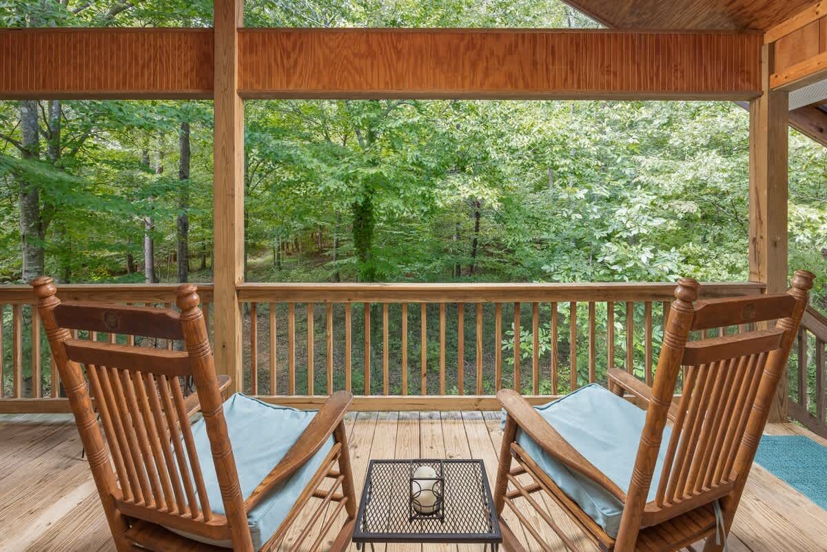 Rocking chairs on the porch facing the woods
