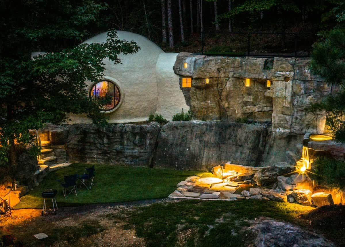 The dome and rock walls glowing with lights at night