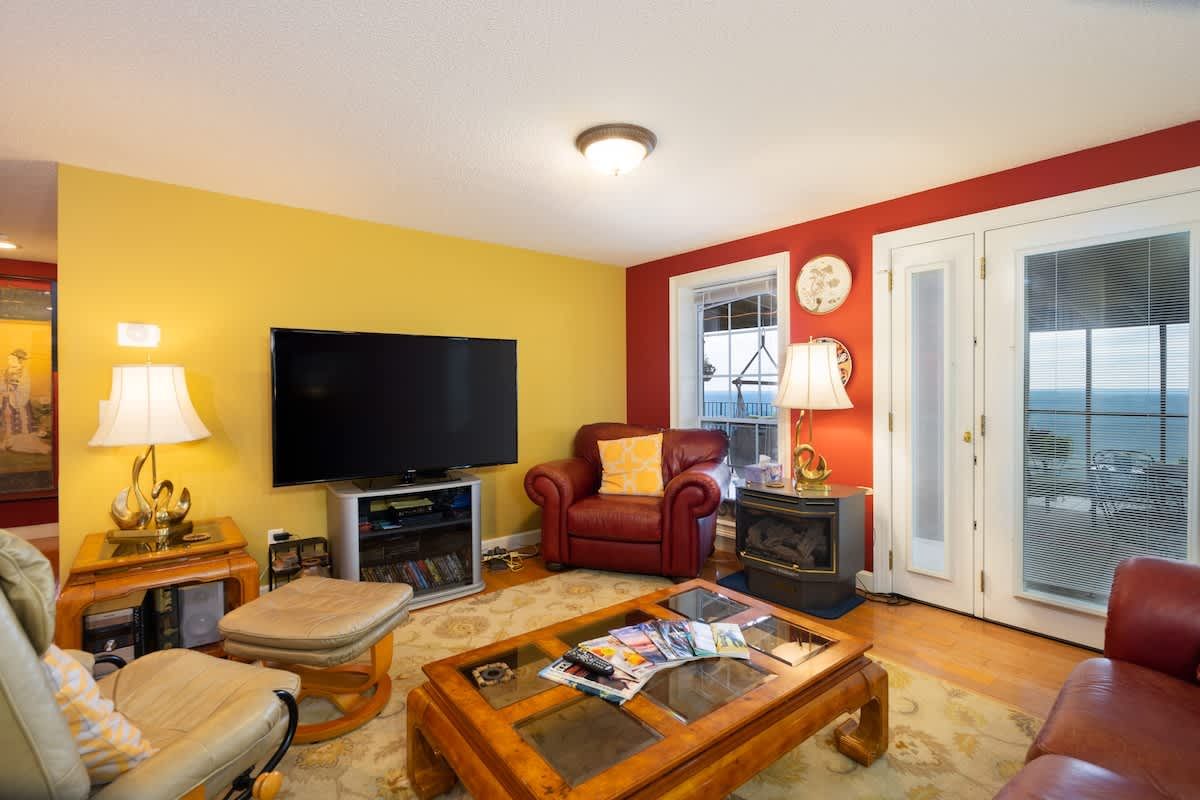 Living room with a big TV and doors out to the view