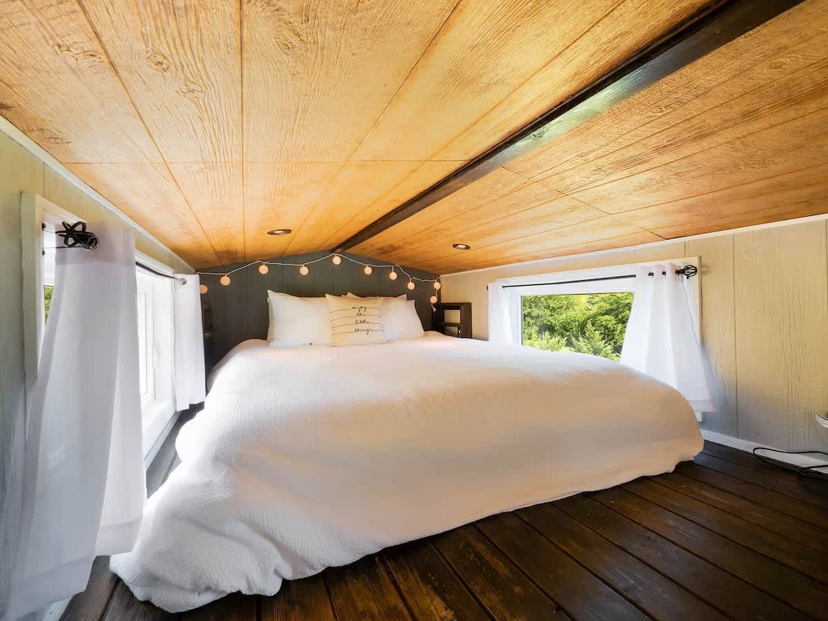 Queen bed in the loft with string lights