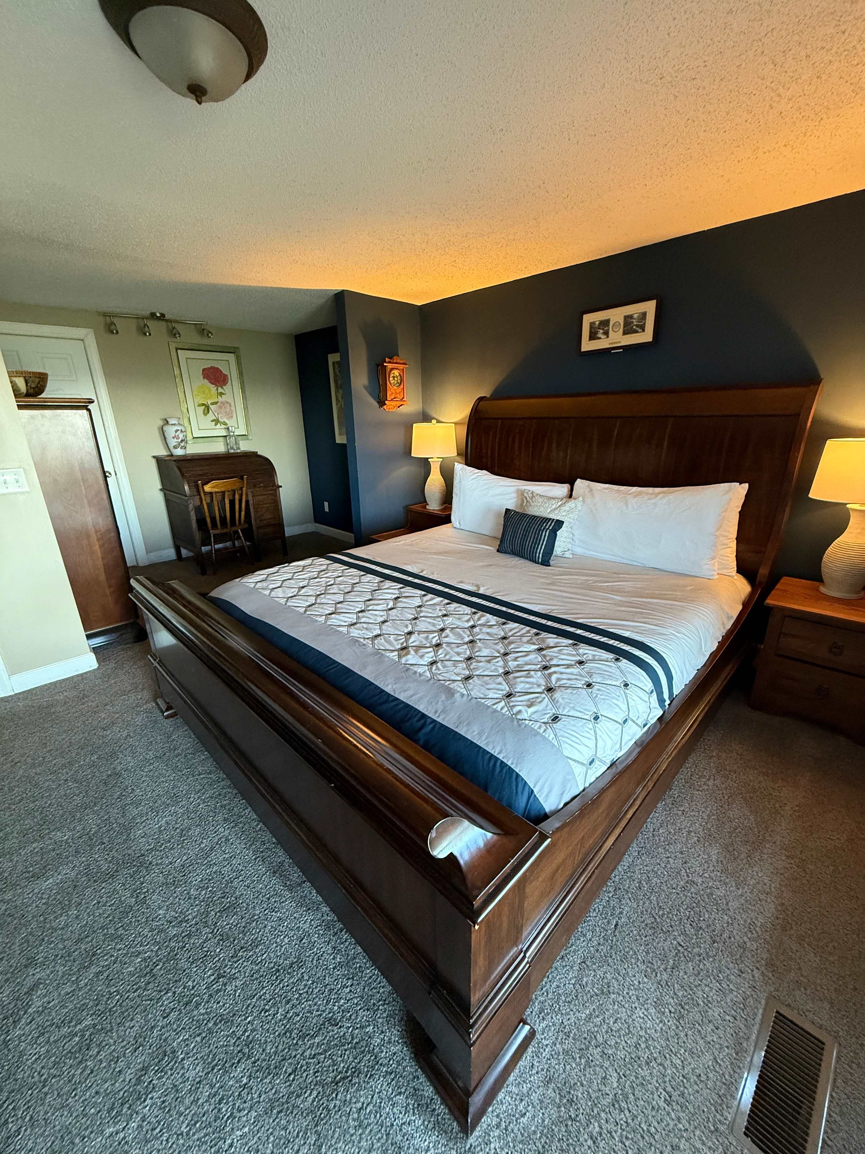 King bedroom with a dark wood bed