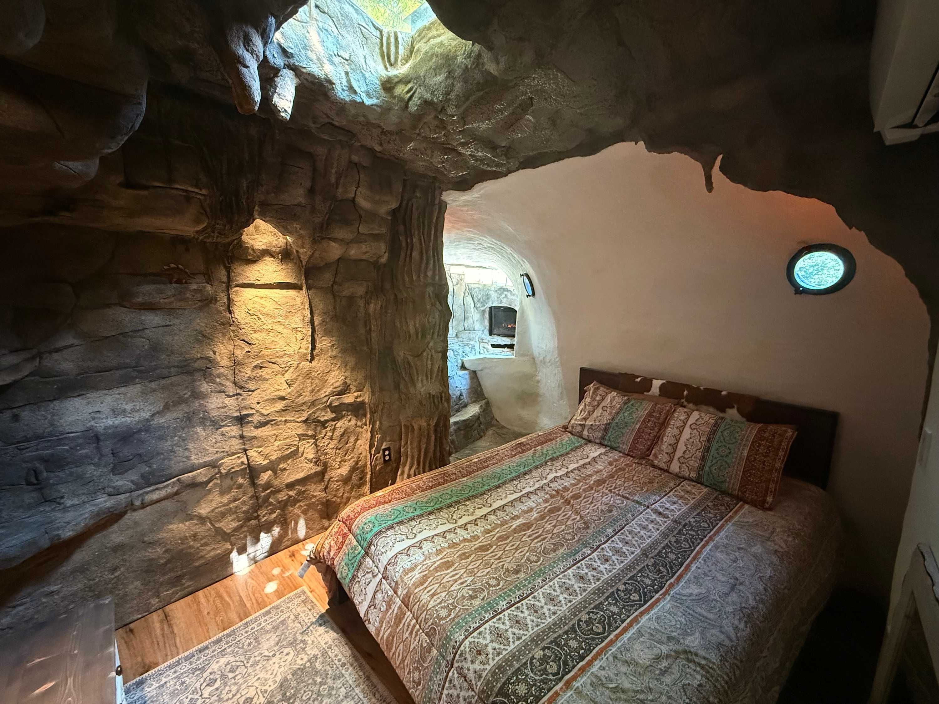 Cave-style bedroom with rock walls and soft lighting