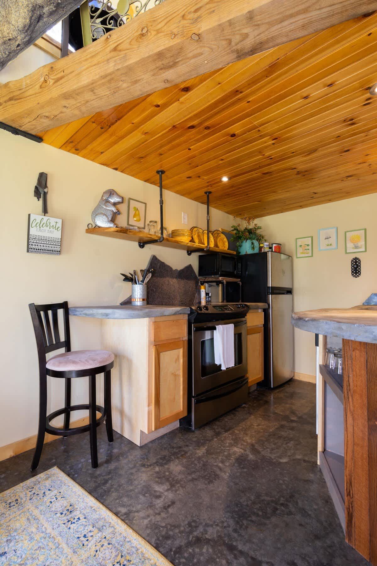 Kitchen with stone counters and open wooden shelves