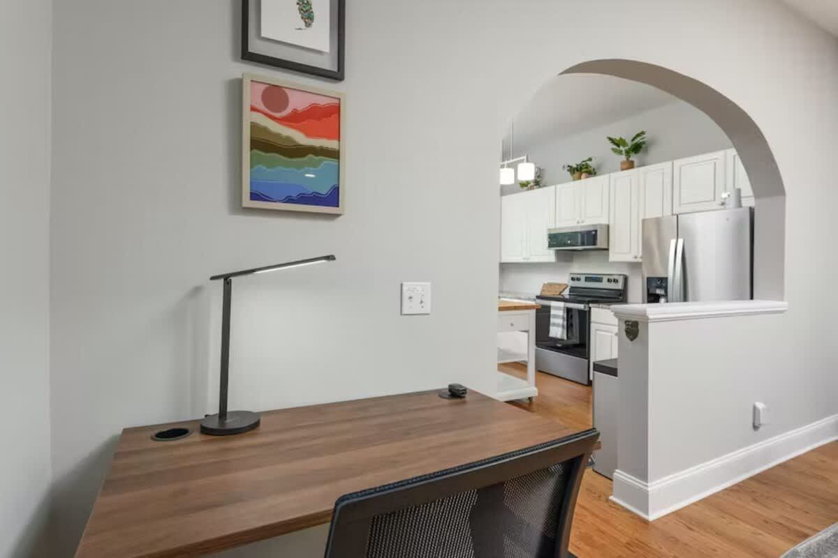 Desk beside an arched doorway to the kitchen