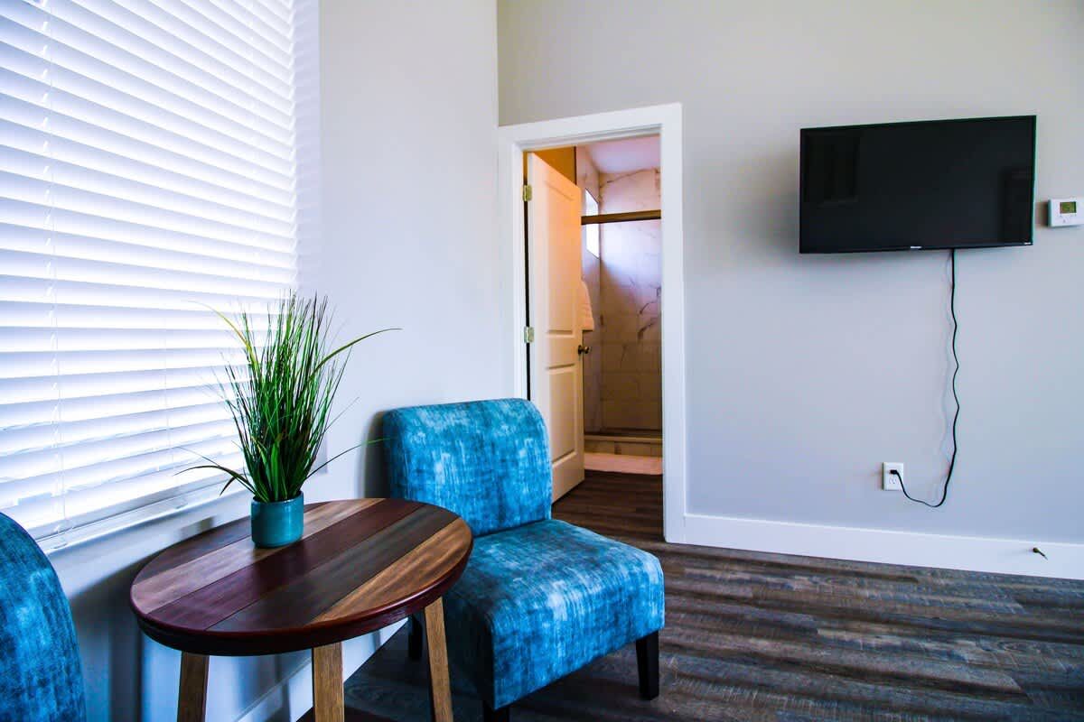 Sitting area with blue chairs in a bedroom