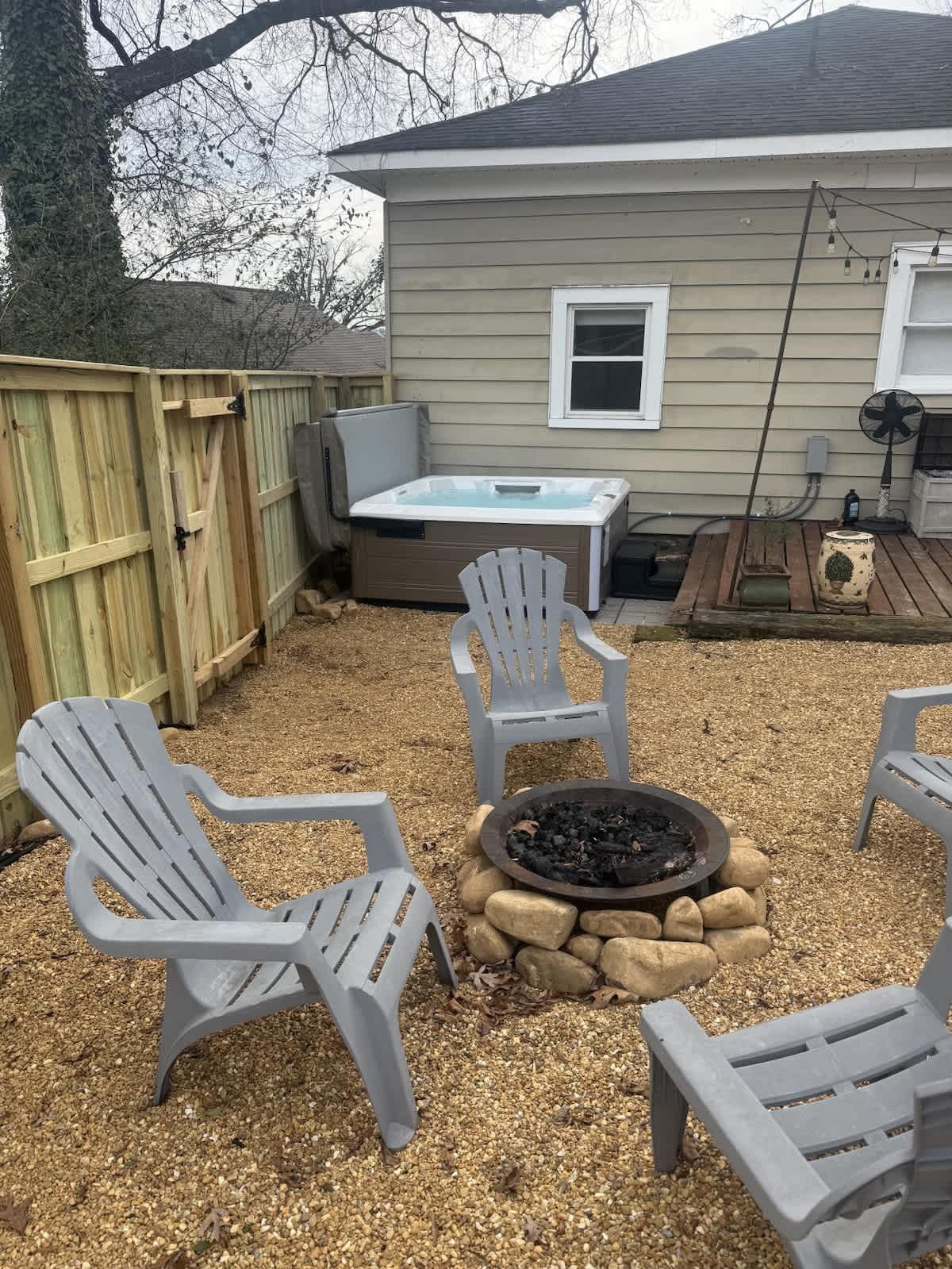Fire pit with Adirondack chairs in the backyard