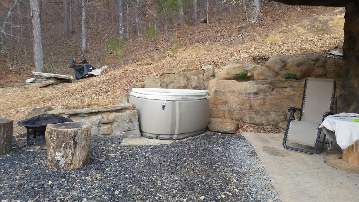 Hot tub set into a rock outcrop beside the cottage