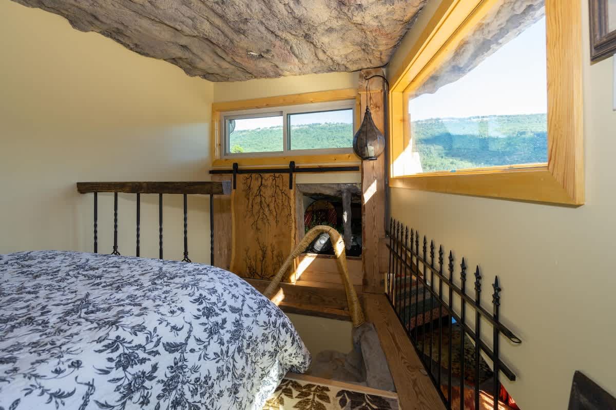 Loft bedroom with windows facing the mountain