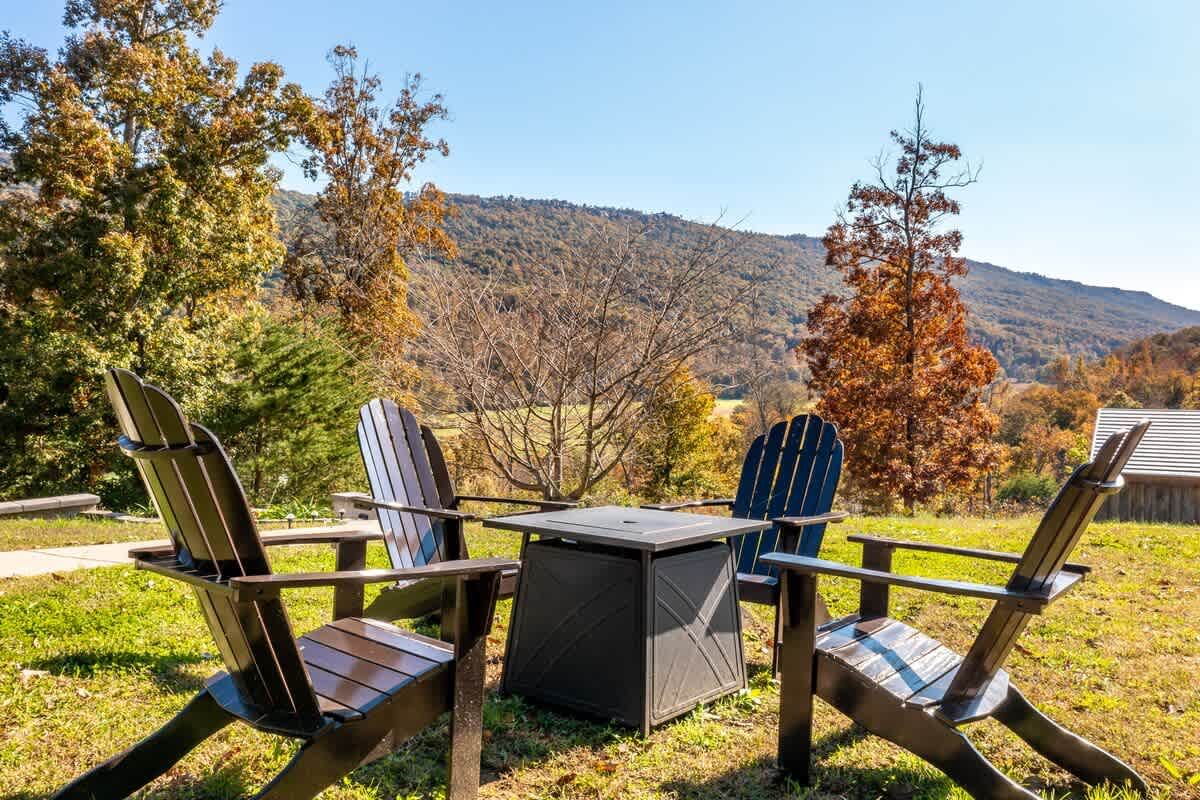 Adirondack chairs around the fire pit in fall